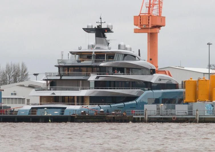 a large boat docked at a pier aboard AVIVA Yacht for Sale