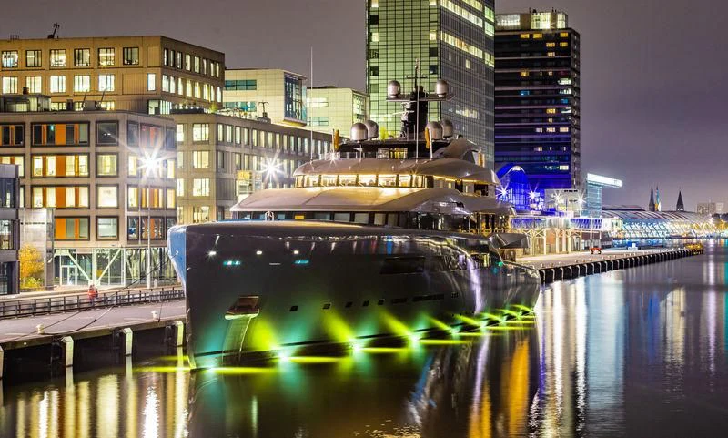 a boat on water with buildings in the background aboard AVIVA Yacht for Sale