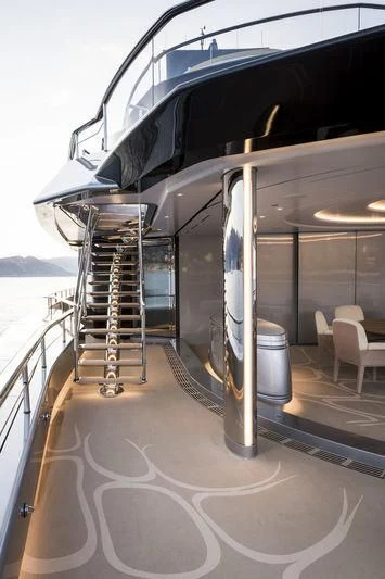 a large glass wall with a staircase aboard AVIVA Yacht for Sale