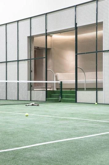 a tennis racket and ball on a court aboard AVIVA Yacht for Sale
