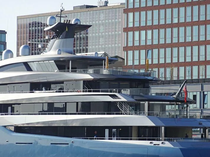 a plane flying over a building aboard AVIVA Yacht for Sale