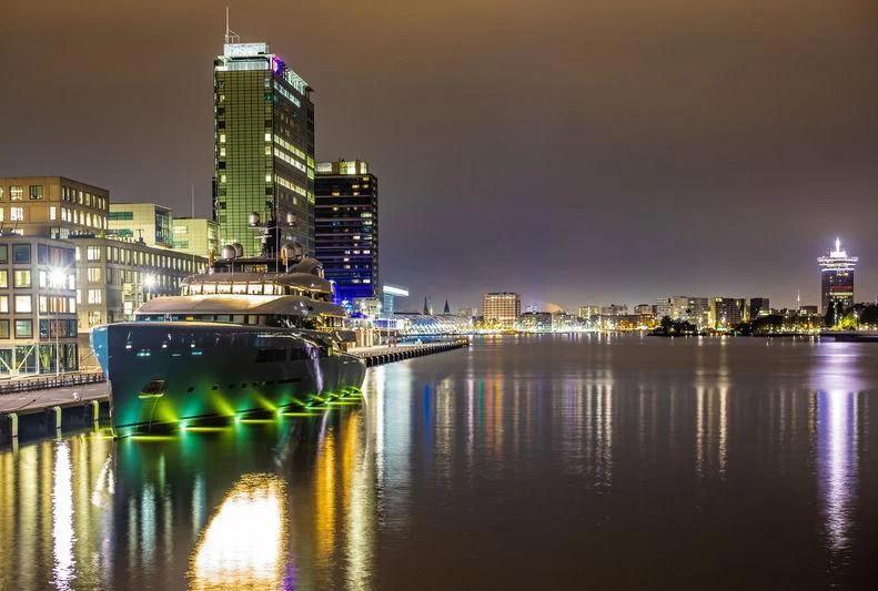 a bridge over water with buildings in the background aboard AVIVA Yacht for Sale