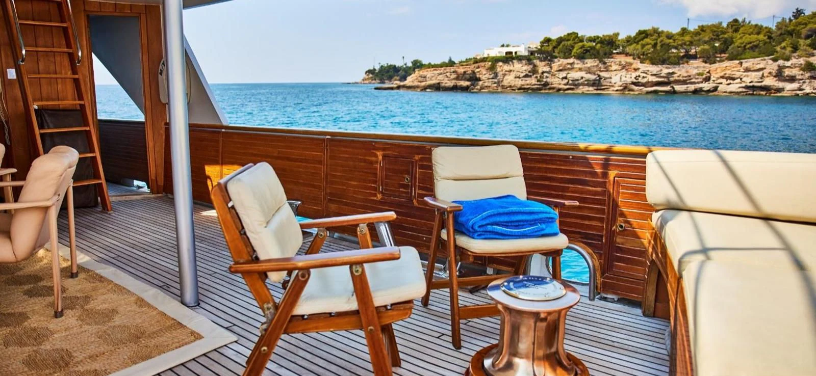 a boat dock with chairs and a table on it aboard AETEA Yacht for Sale