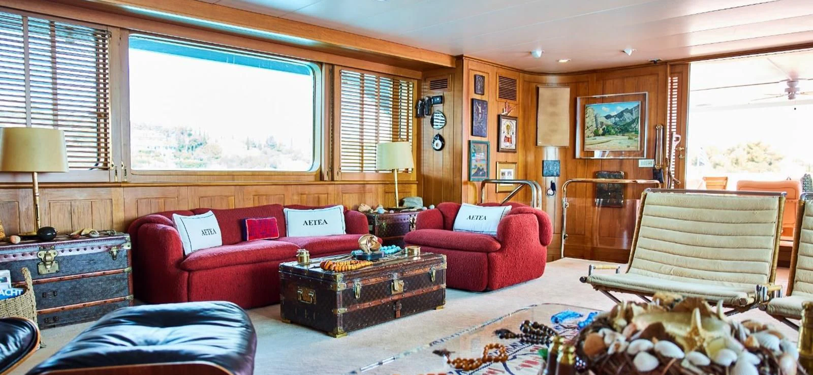 a living room with a red couch and a coffee table aboard AETEA Yacht for Sale