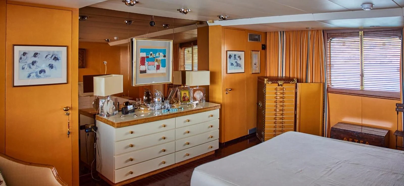 a bedroom with a bed and a desk aboard AETEA Yacht for Sale