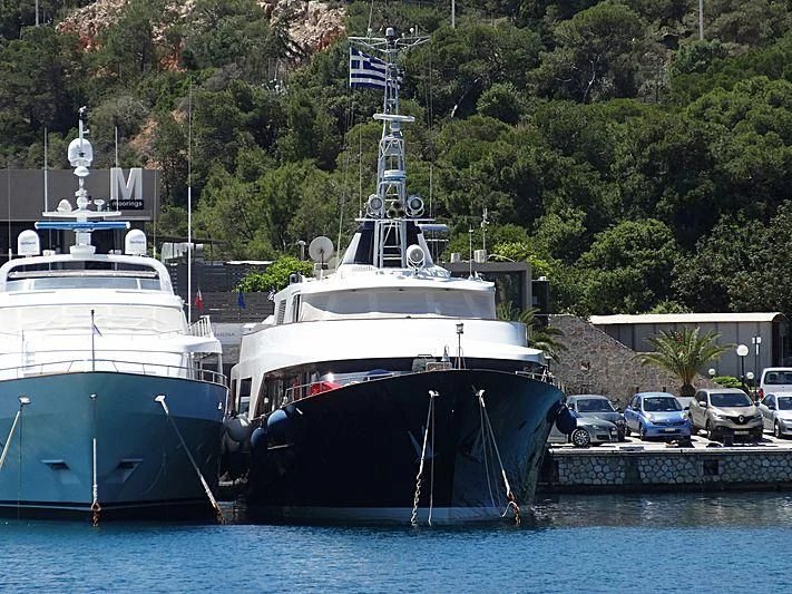 a couple of large boats are parked in a harbor aboard AETEA Yacht for Sale