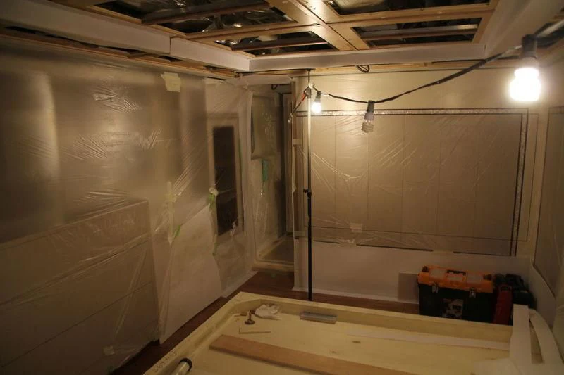 a room with a white wall and a wooden table and a white wall aboard RASHA Yacht for Sale
