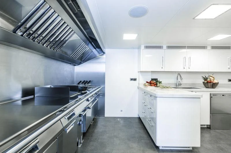 a kitchen with white cabinets aboard RASHA Yacht for Sale