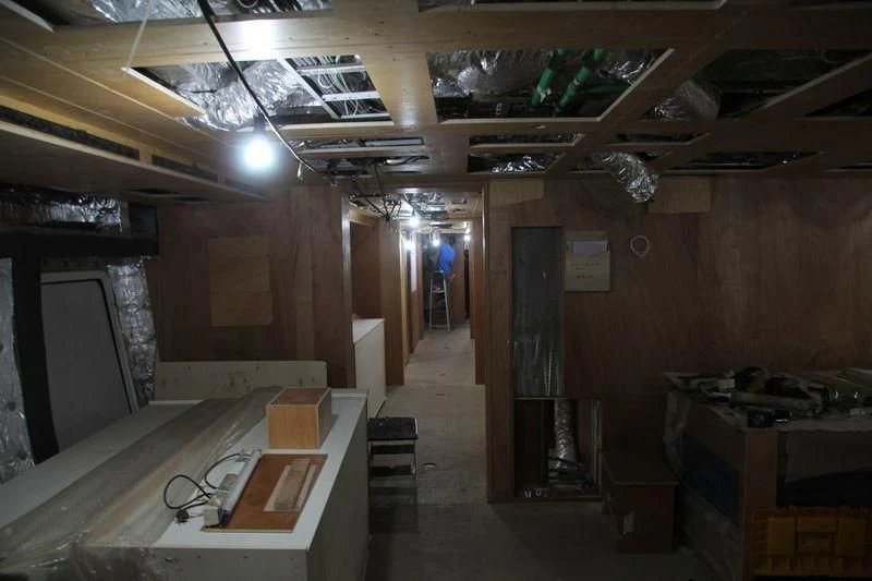 a room with tables and chairs aboard RASHA Yacht for Sale
