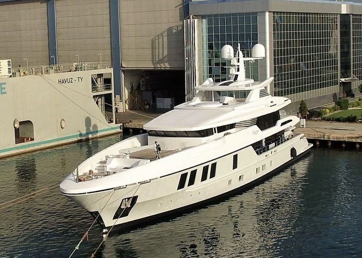 a white boat docked at a pier aboard RASHA Yacht for Sale