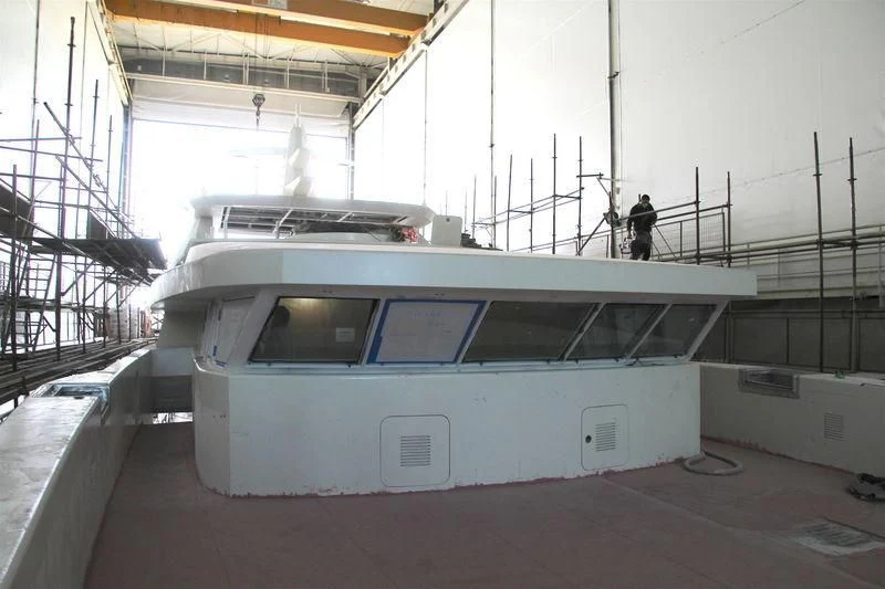 a white boat in a building aboard RASHA Yacht for Sale