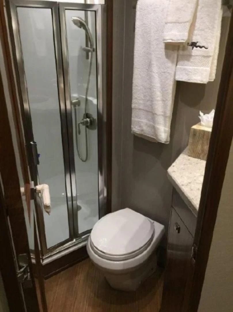 a bathroom with a glass shower aboard GALATI  TRADE Yacht for Sale