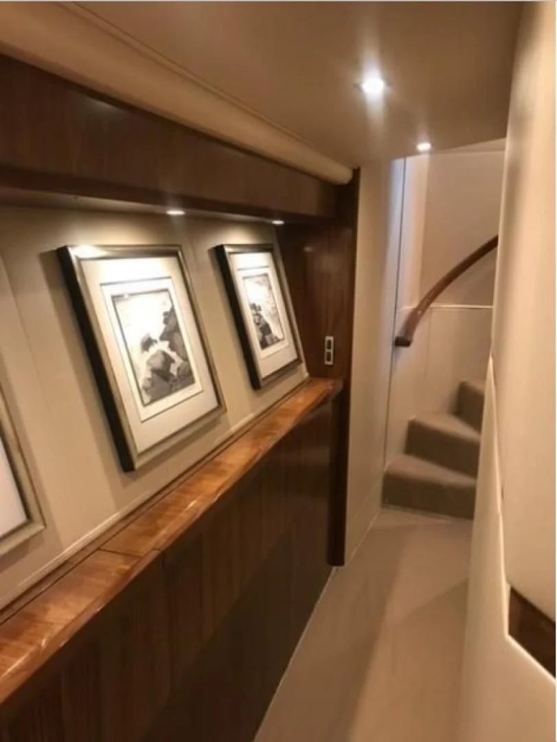 a staircase with pictures on the wall aboard GALATI  TRADE Yacht for Sale