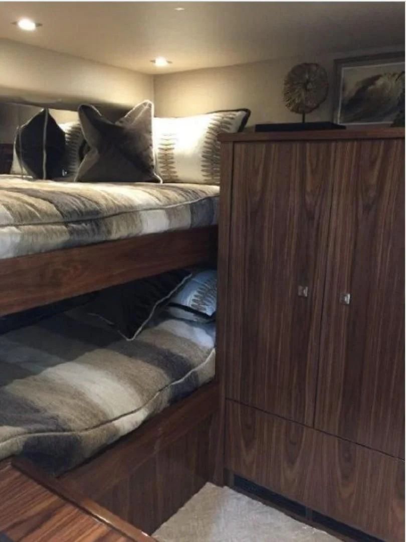 a bed with a wooden headboard aboard GALATI  TRADE Yacht for Sale