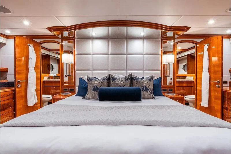 a bed with a white sheet and pillows aboard BRANDI WINE Yacht for Charter