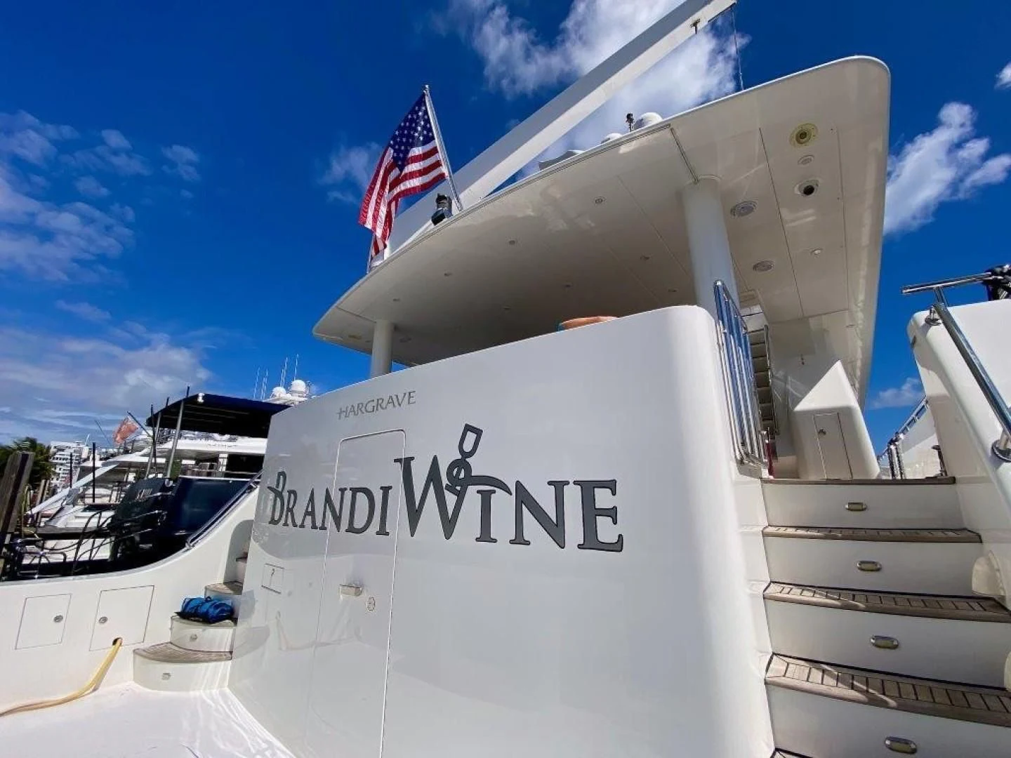a large white ship with a flag on top aboard BRANDI WINE Yacht for Charter