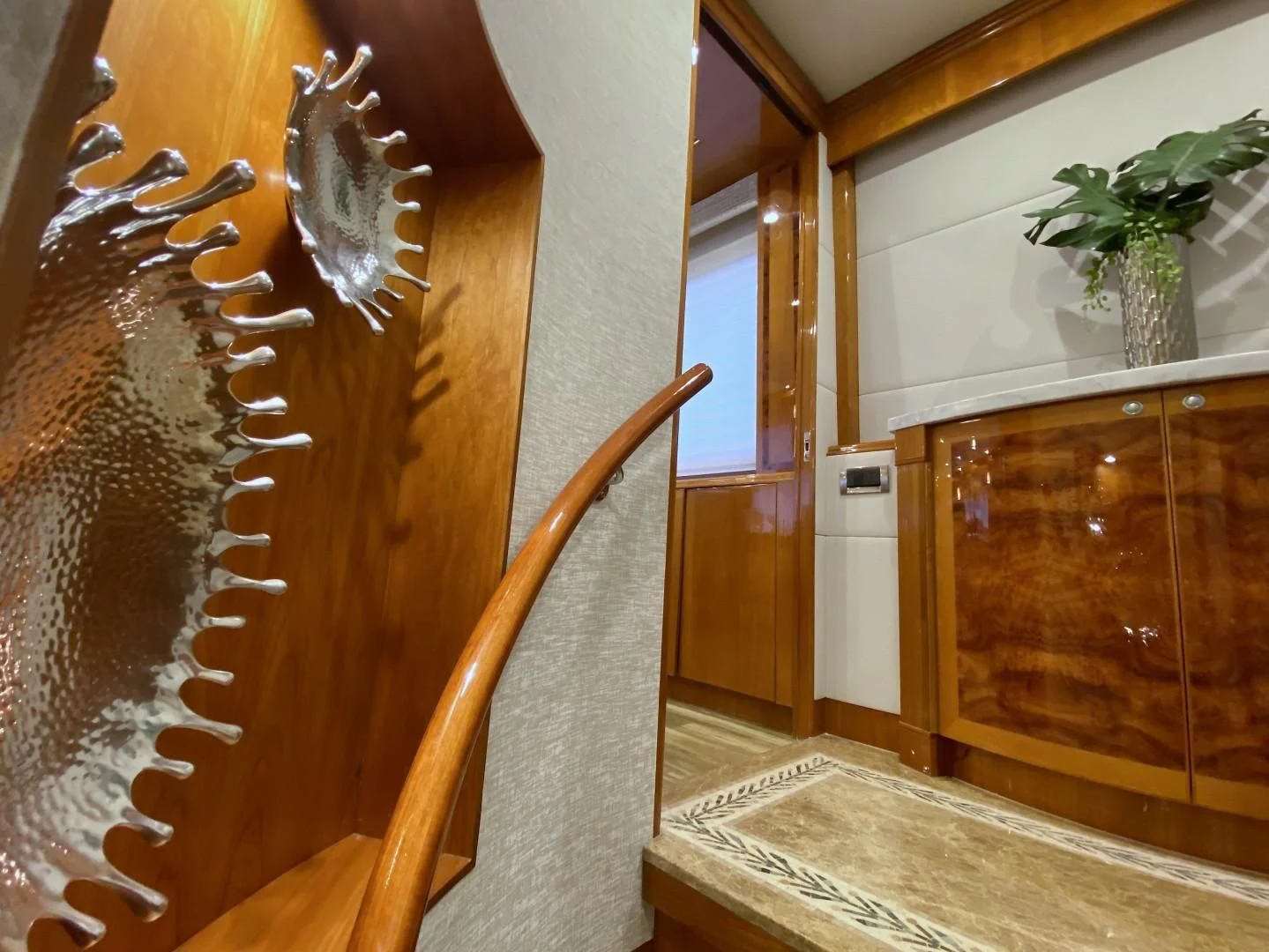 a staircase with a plant on the side aboard BRANDI WINE Yacht for Charter