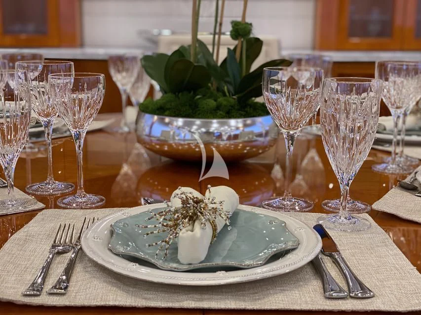 a plate of food and glasses aboard BRANDI WINE Yacht for Charter