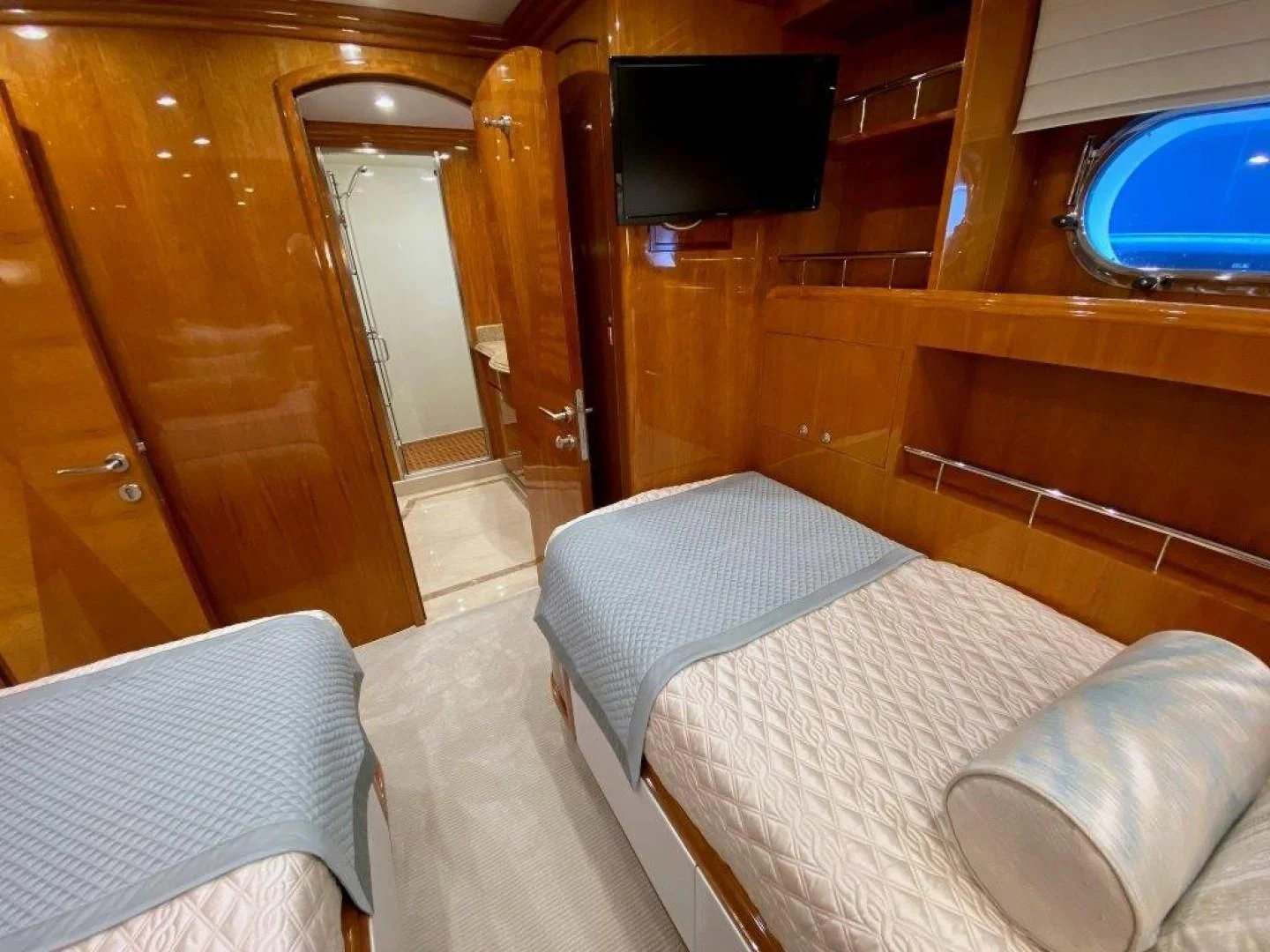 a room with a bed and a tv on the wall aboard BRANDI WINE Yacht for Charter