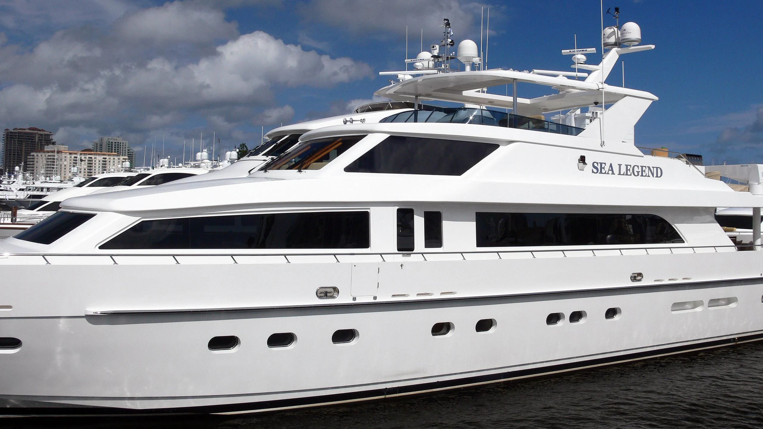 a white yacht in a harbor aboard BRANDI WINE Yacht for Charter