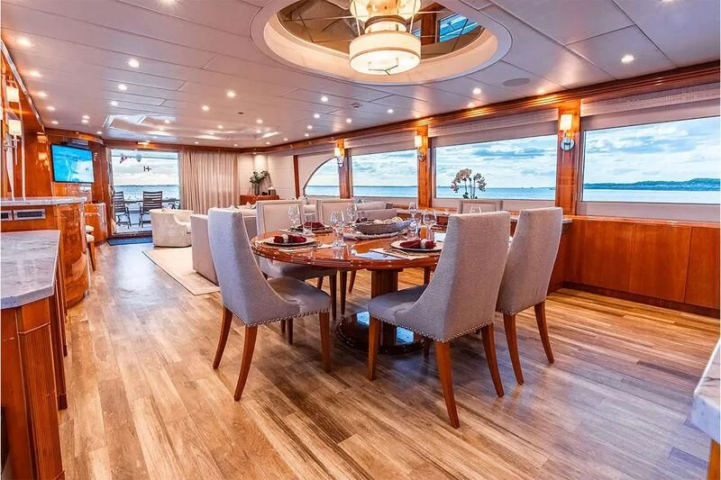 a large dining room with a large table and chairs aboard BRANDI WINE Yacht for Charter