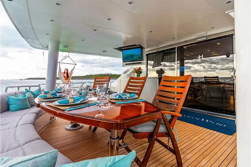 a dining table on a deck aboard BRANDI WINE Yacht for Charter