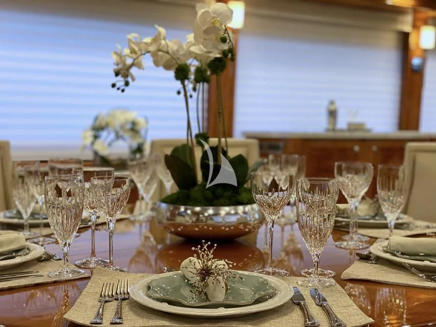 a table with plates and glasses aboard BRANDI WINE Yacht for Charter