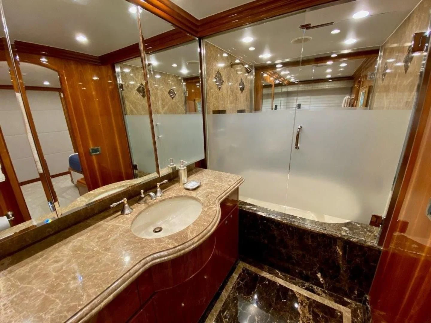 a bathroom with a countertop sink and a large mirror aboard BRANDI WINE Yacht for Charter