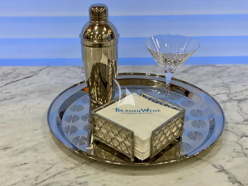 a bottle of perfume on a plate aboard BRANDI WINE Yacht for Charter