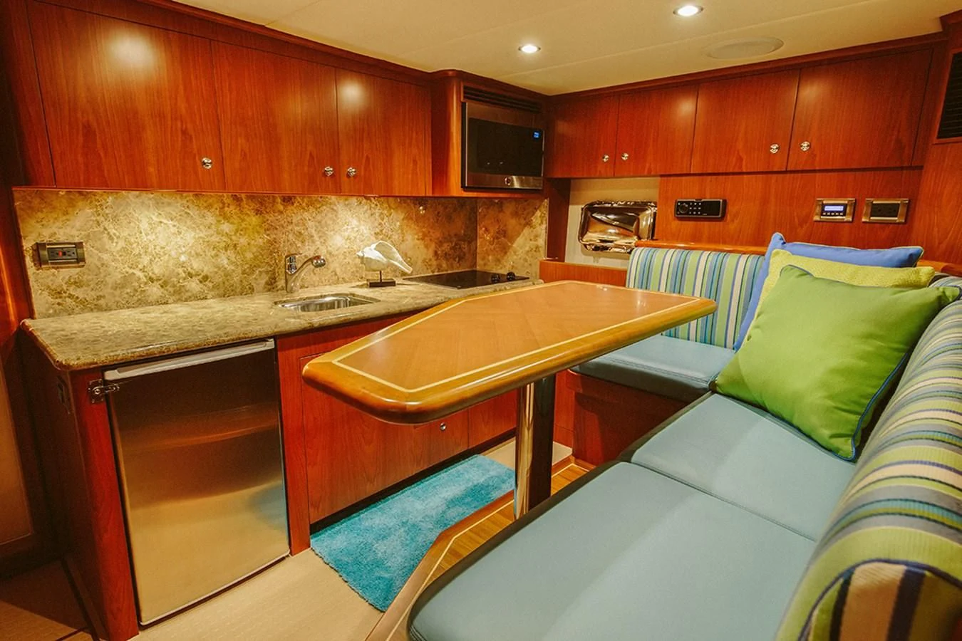 a kitchen with a table and a couch aboard 44 NORTH Yacht for Sale