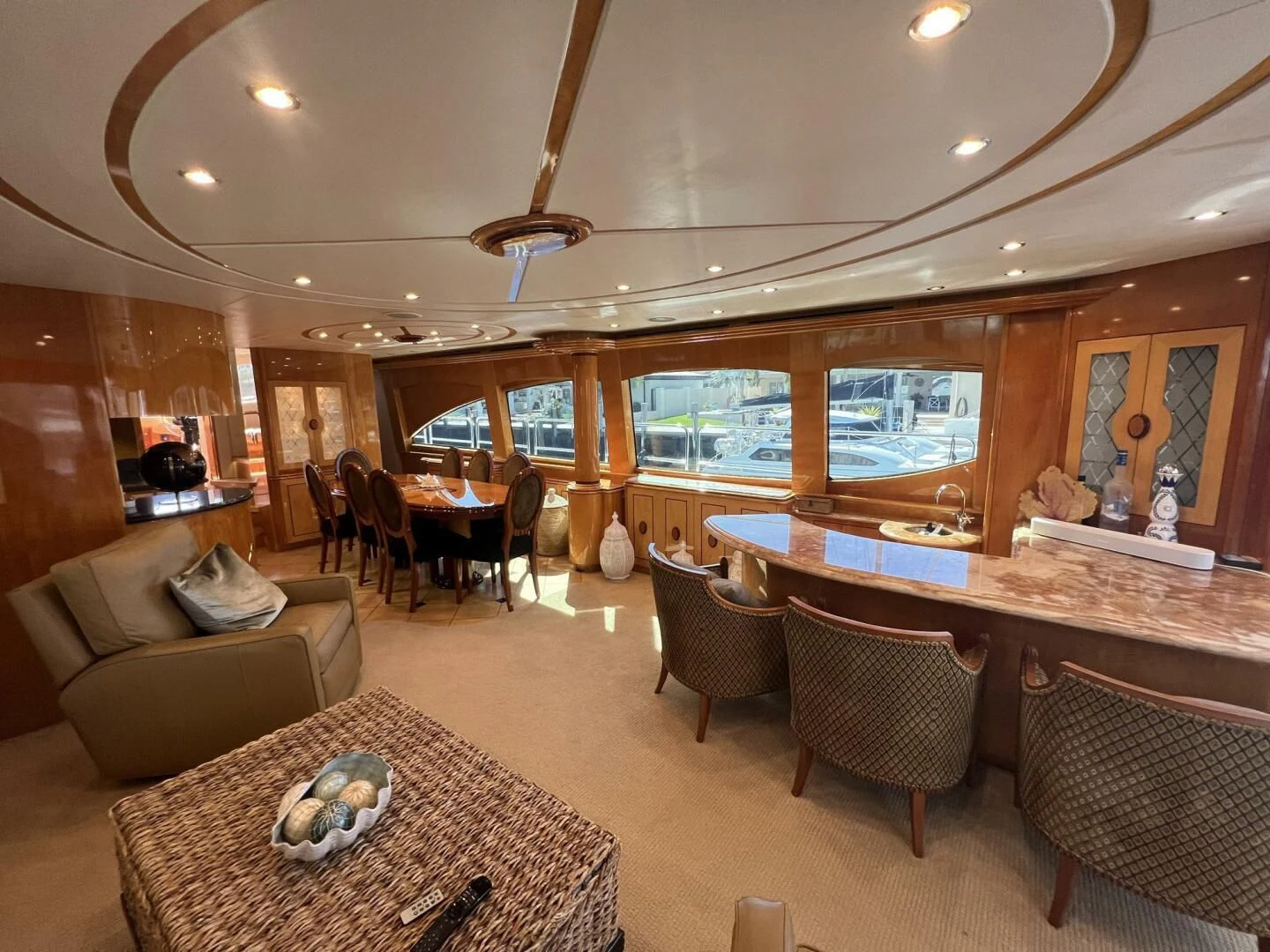 a large living room with a large table and chairs aboard ARETECTE Yacht for Sale