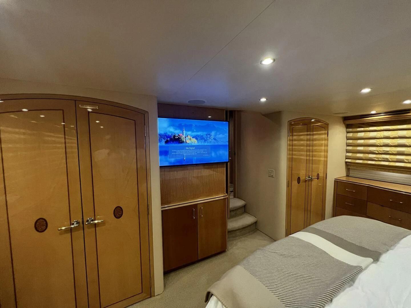 a bedroom with a tv and a bed aboard ARETECTE Yacht for Sale