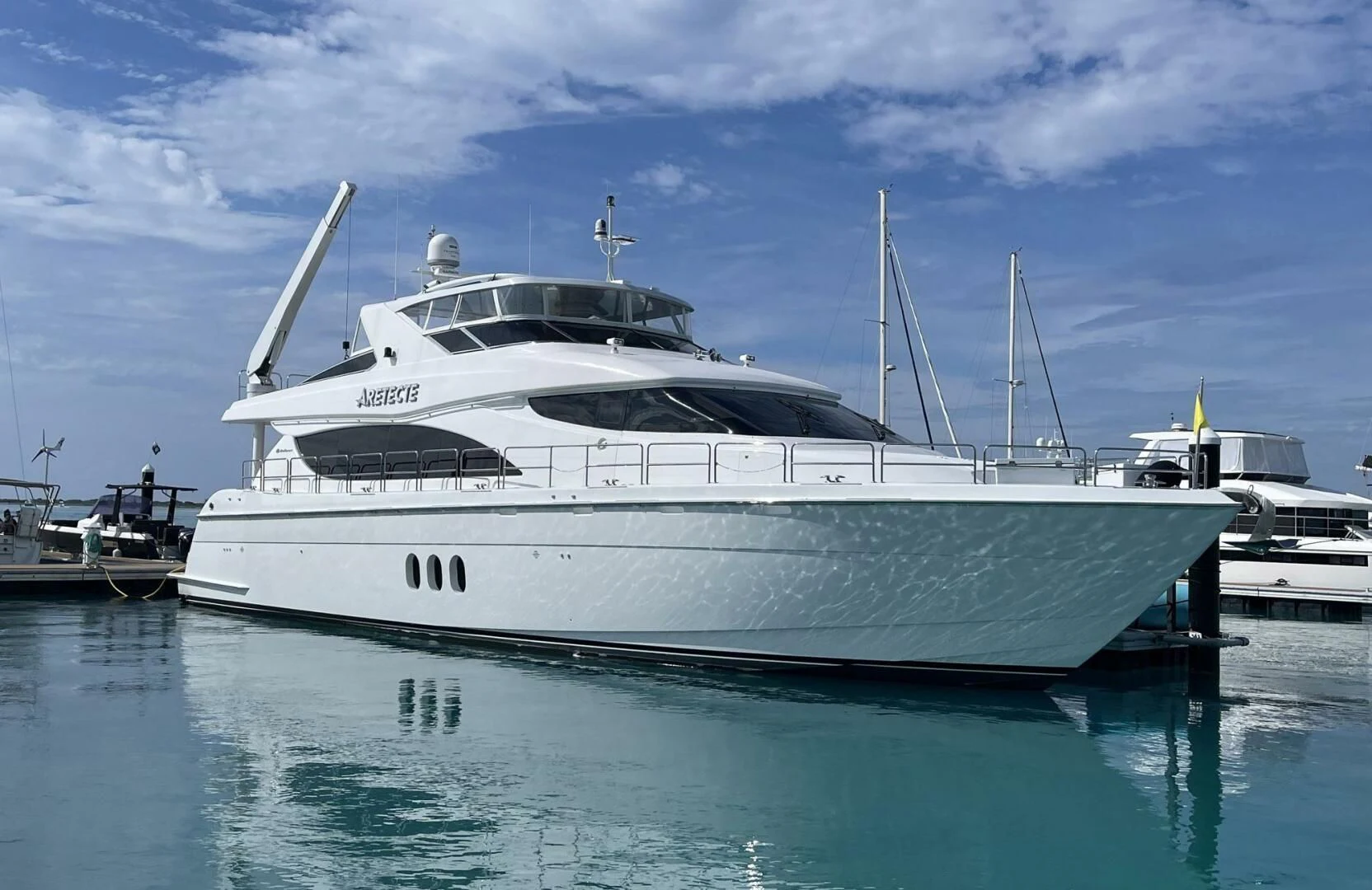 a white yacht in the water aboard ARETECTE Yacht for Sale