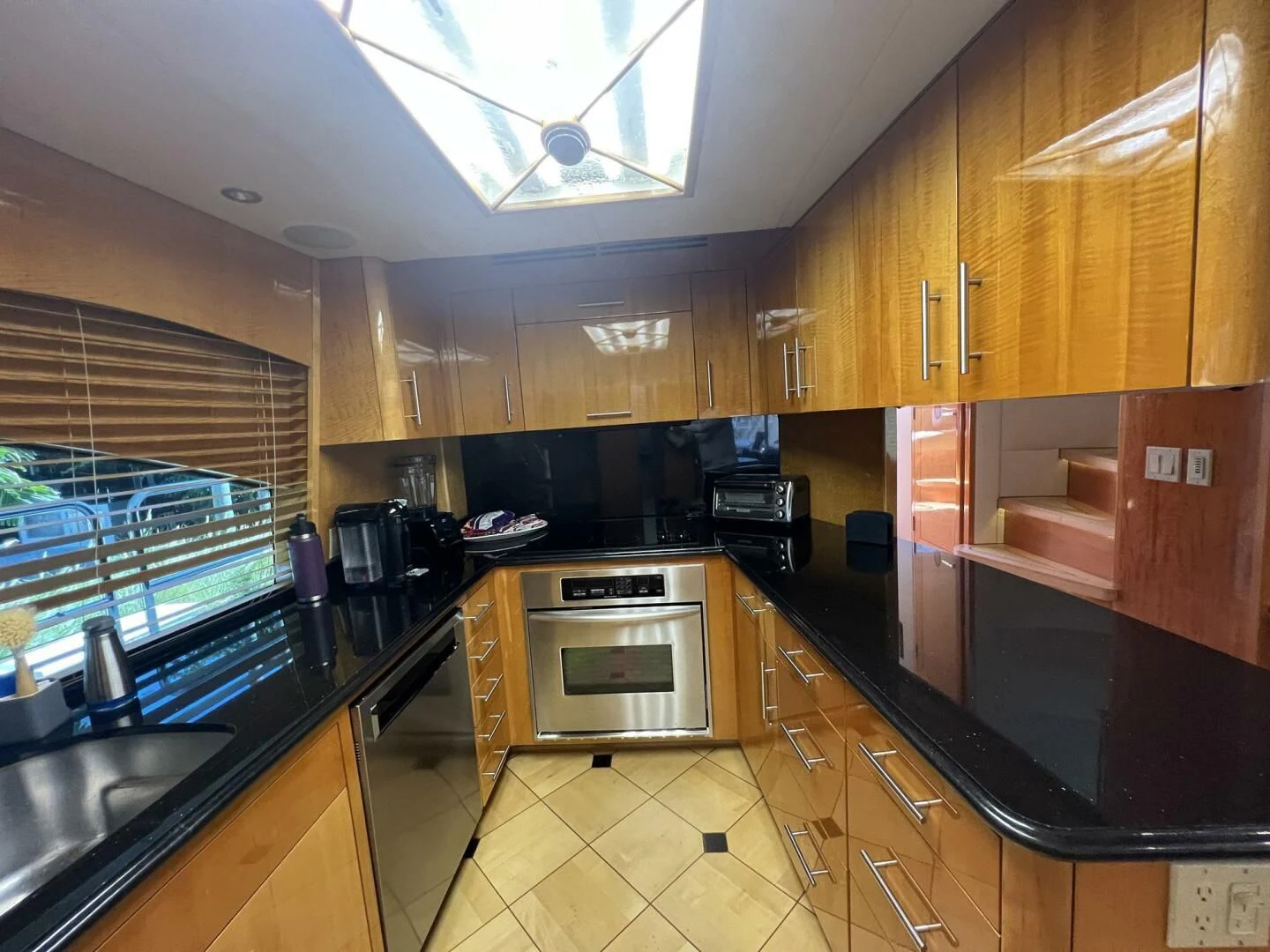 a kitchen with wooden cabinets aboard ARETECTE Yacht for Sale