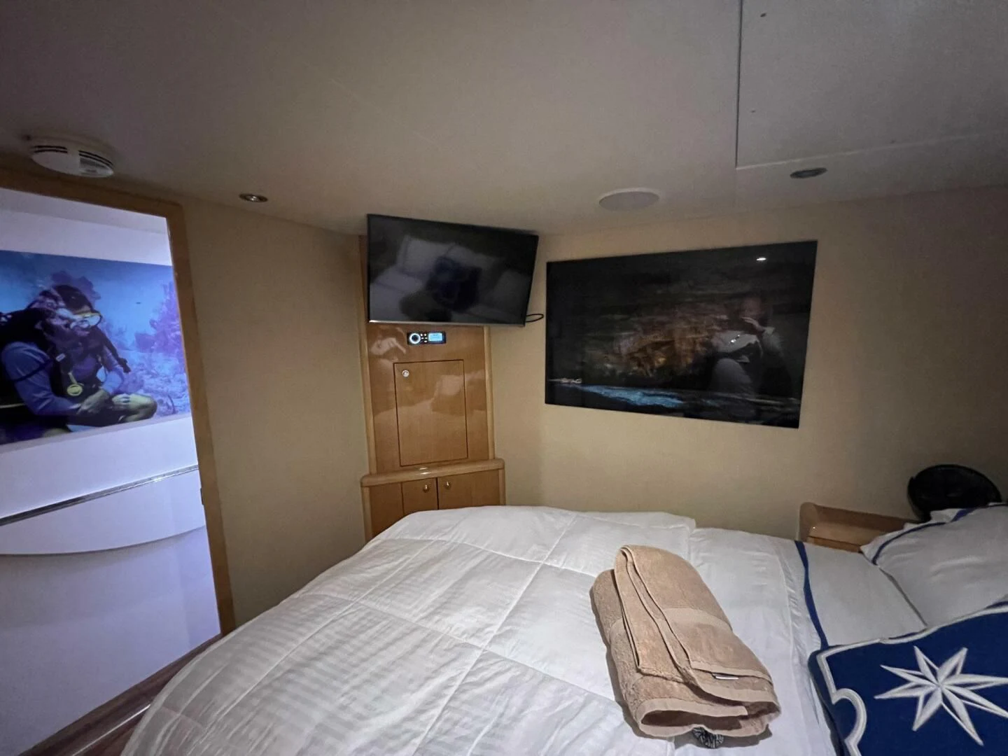 a bedroom with a television on the wall aboard ARETECTE Yacht for Sale