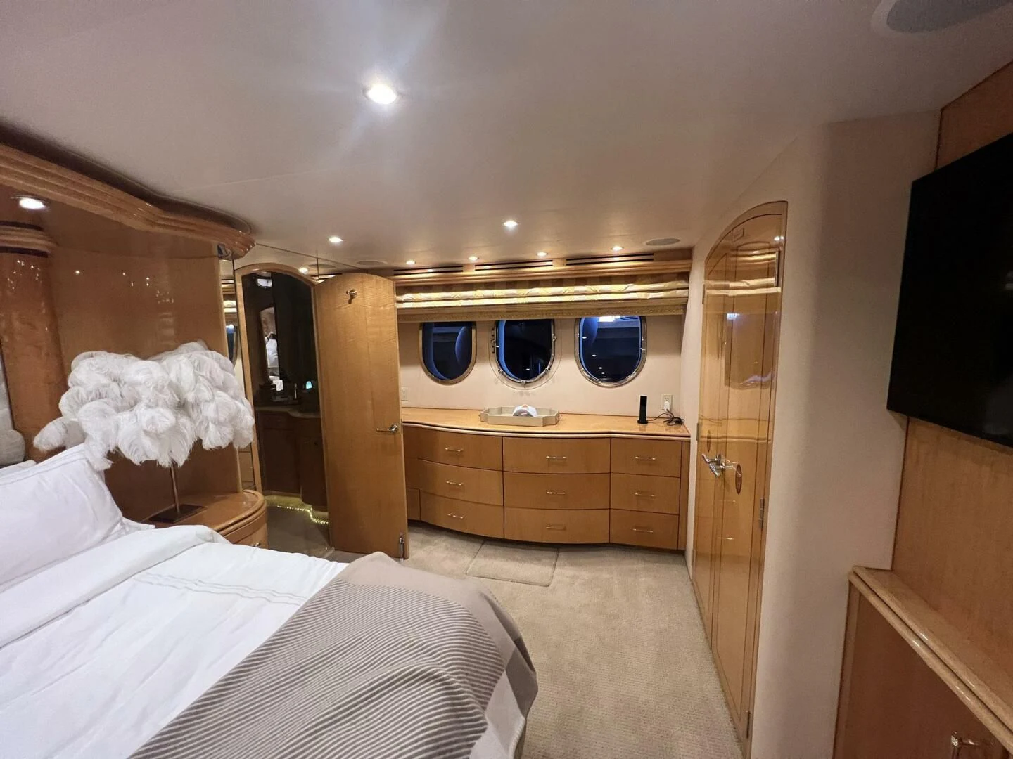 a bedroom with a bed and a mirror aboard ARETECTE Yacht for Sale