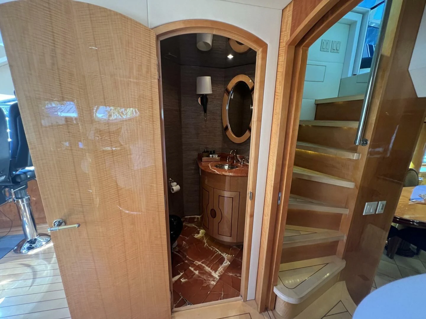 a bathroom with a wood door aboard ARETECTE Yacht for Sale