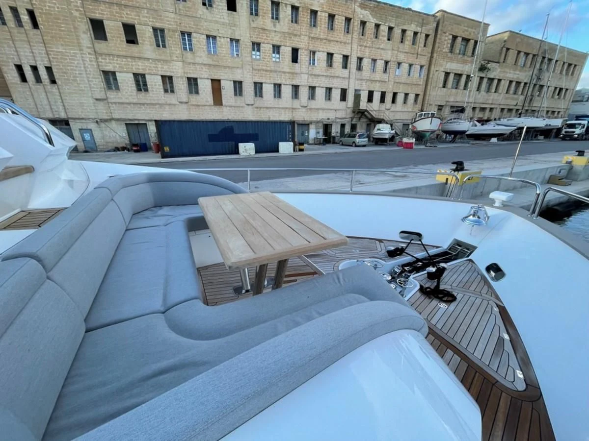 a deck with a group of chairs and tables outside of a building aboard SUNSEEKER 95 Yacht for Sale