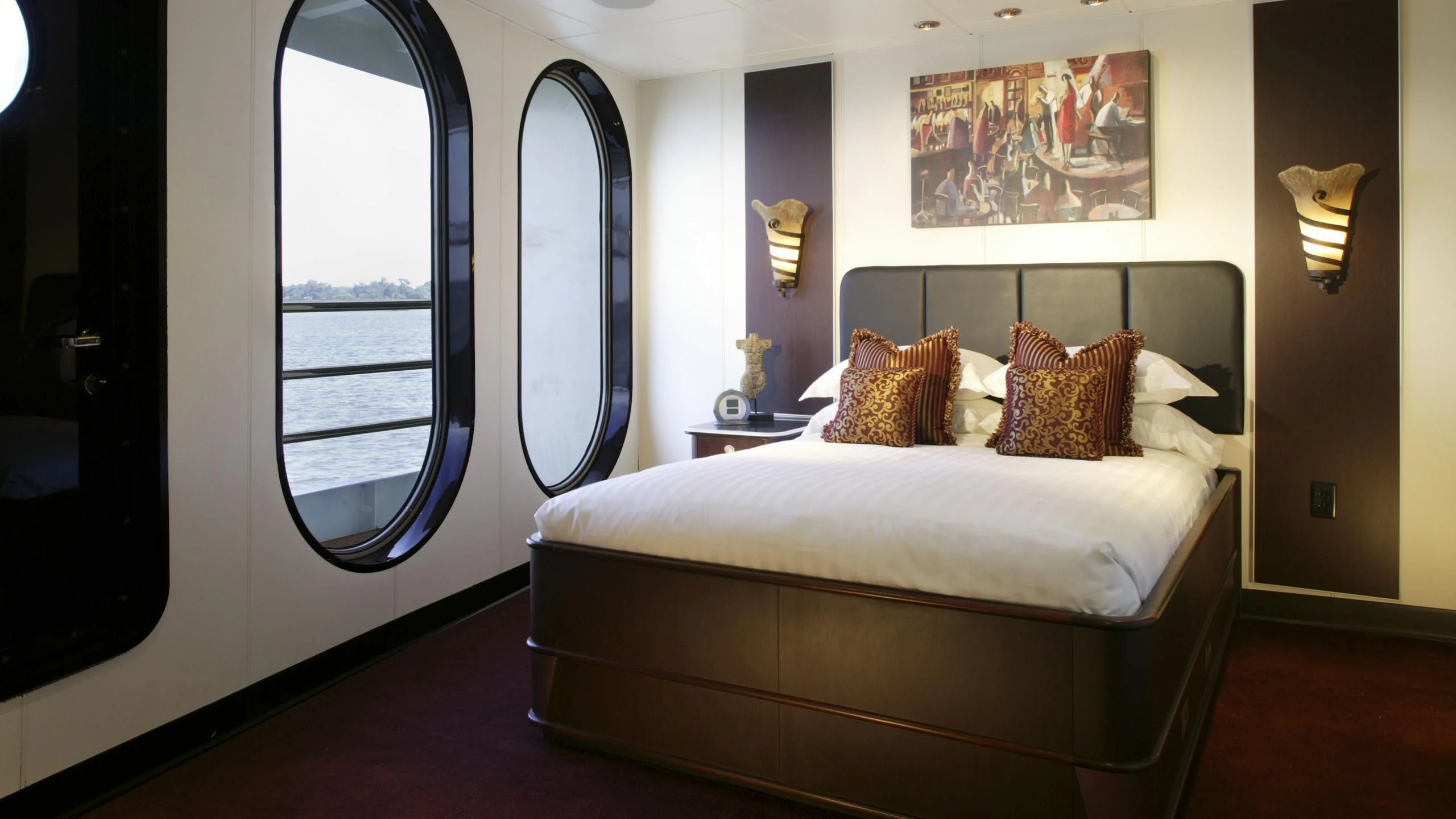 a bed with a white bed aboard GLOBAL Yacht for Sale