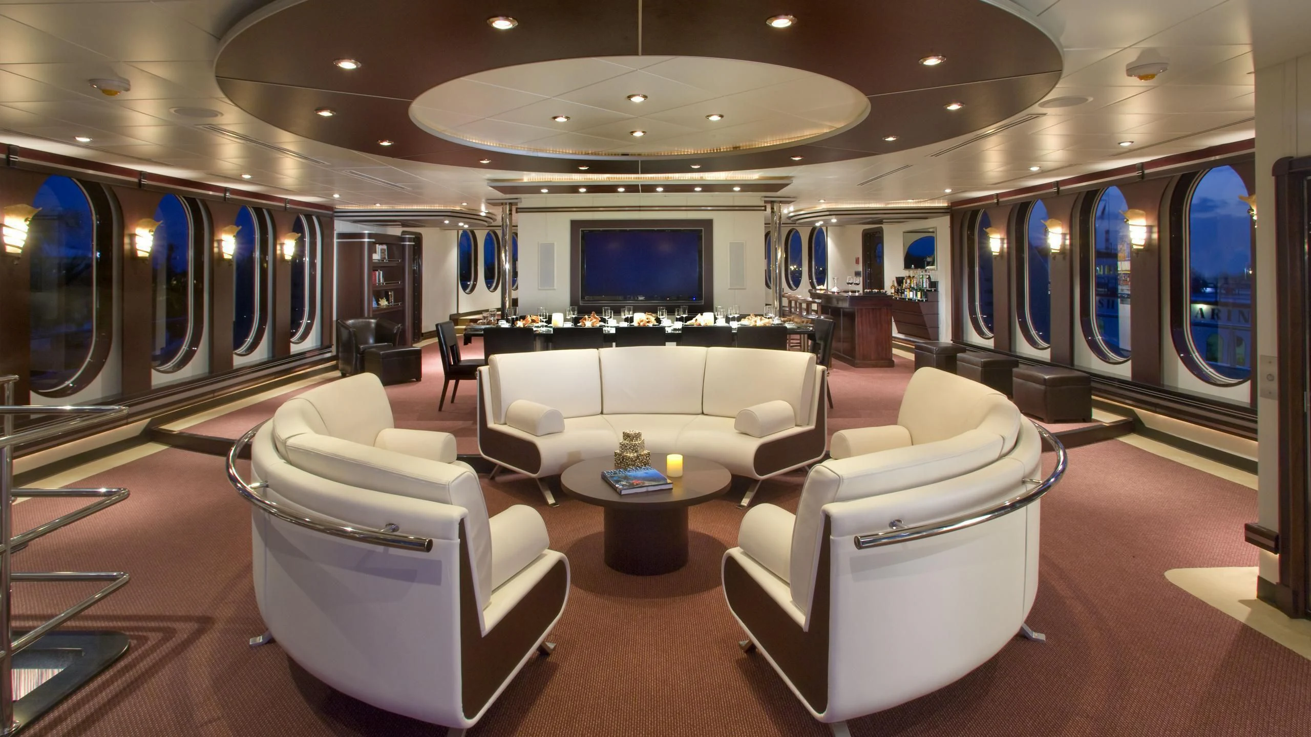 a room with a large white couch and a large screen aboard GLOBAL Yacht for Sale