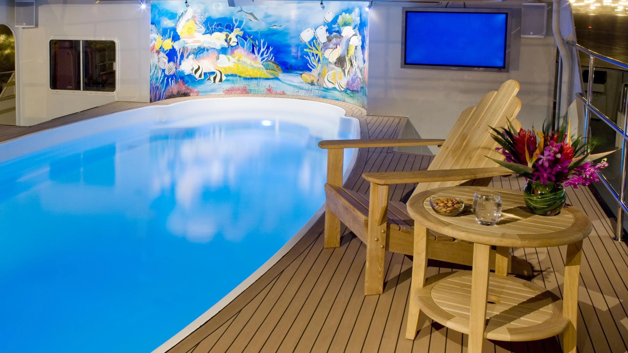 a table and chairs on a deck aboard GLOBAL Yacht for Sale