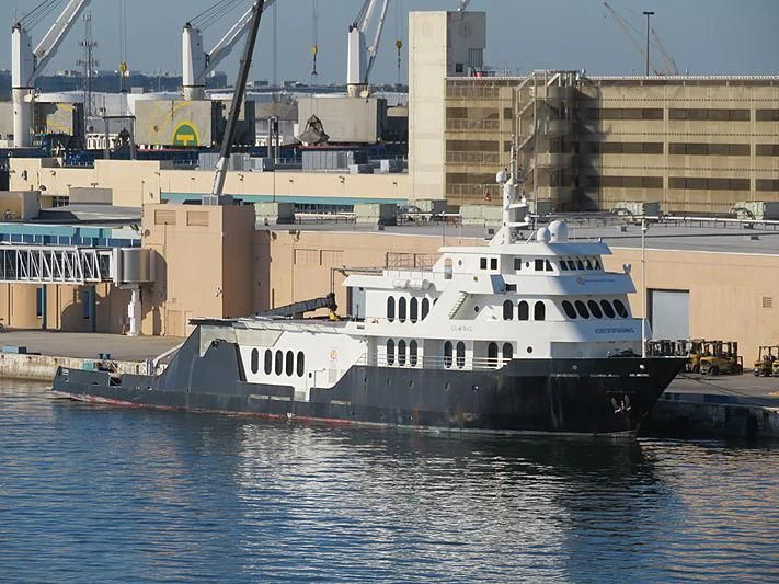 a large white boat in a harbor aboard GLOBAL Yacht for Sale
