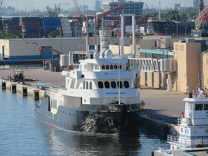 a large white boat docked at a dock aboard GLOBAL Yacht for Sale