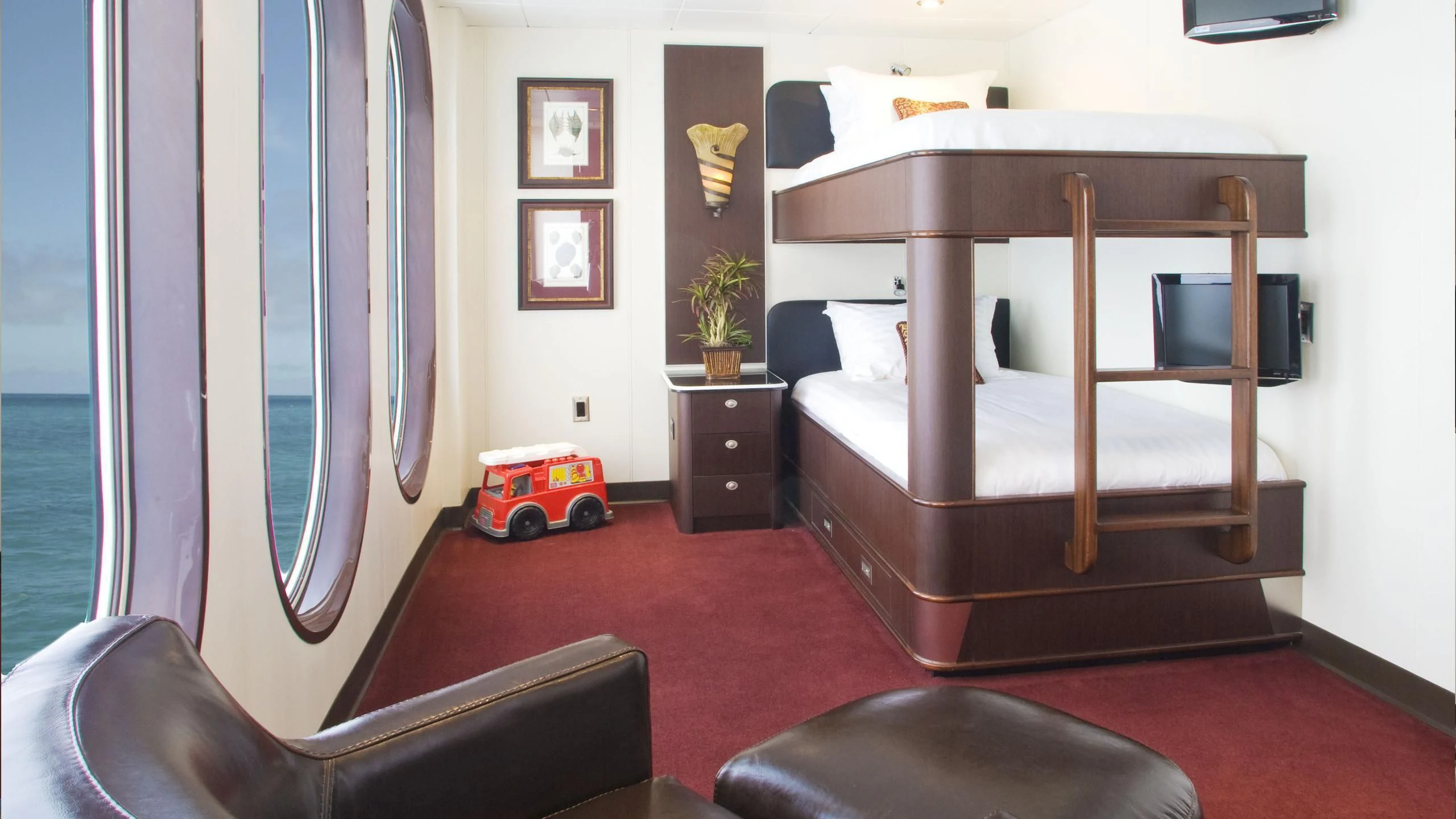 a bedroom with a bed and a desk aboard GLOBAL Yacht for Sale