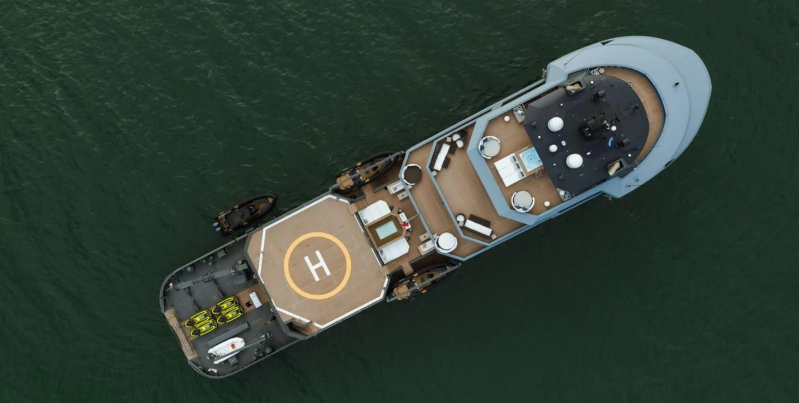 a toy spaceship on a green surface aboard Q Yacht for Sale