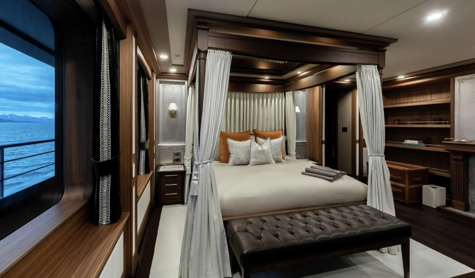 a room with a bed and a window aboard Q Yacht for Sale