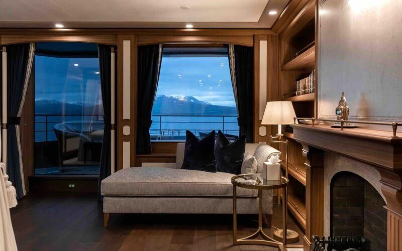 a living room with a fireplace aboard Q Yacht for Sale
