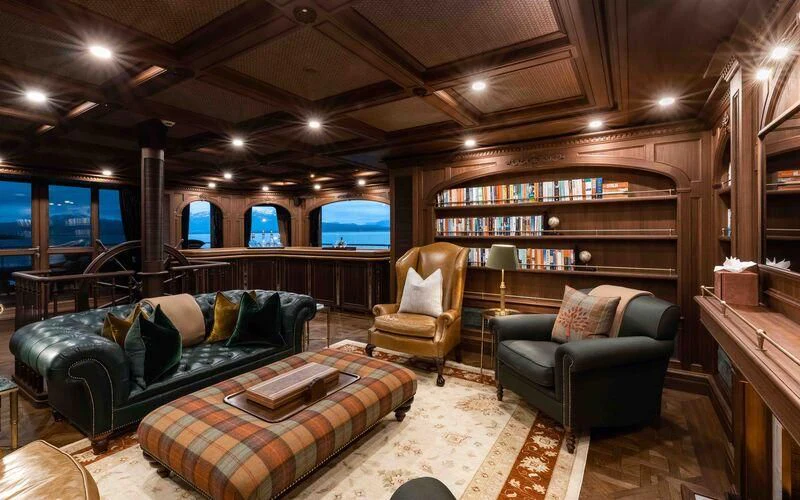 a living room with a couch and a tv aboard Q Yacht for Sale