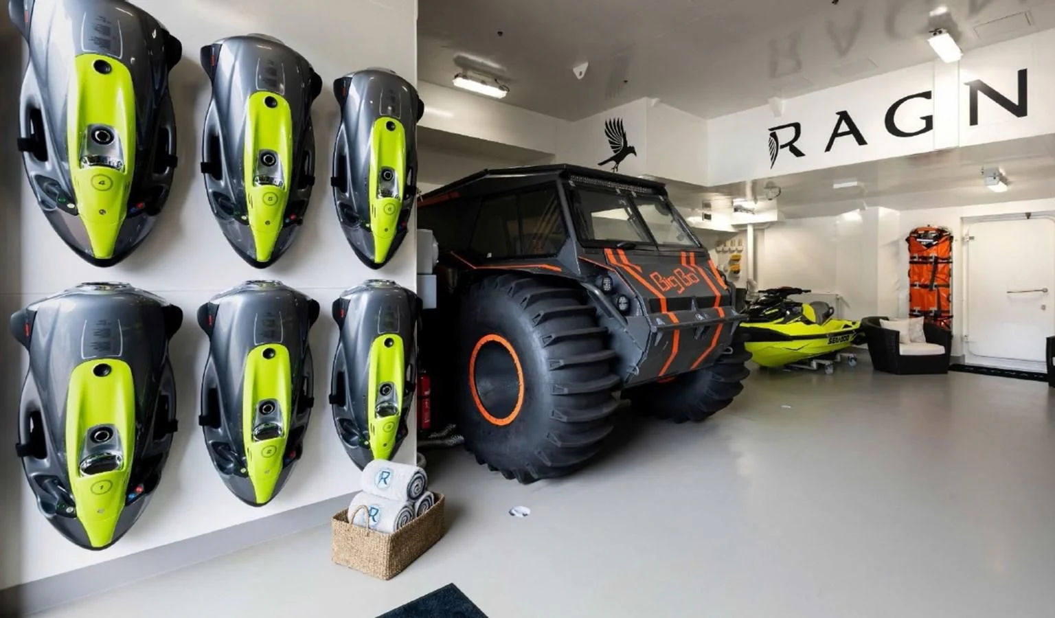 a group of cars in a garage aboard Q Yacht for Sale