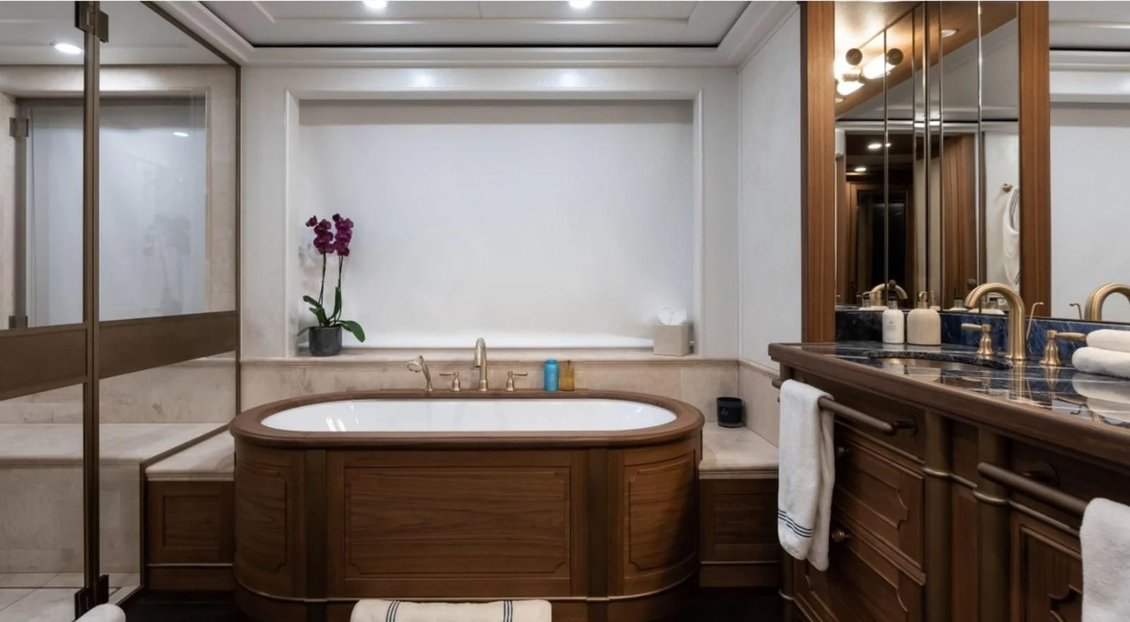 a bathroom with a tub sink and cabinets aboard Q Yacht for Sale